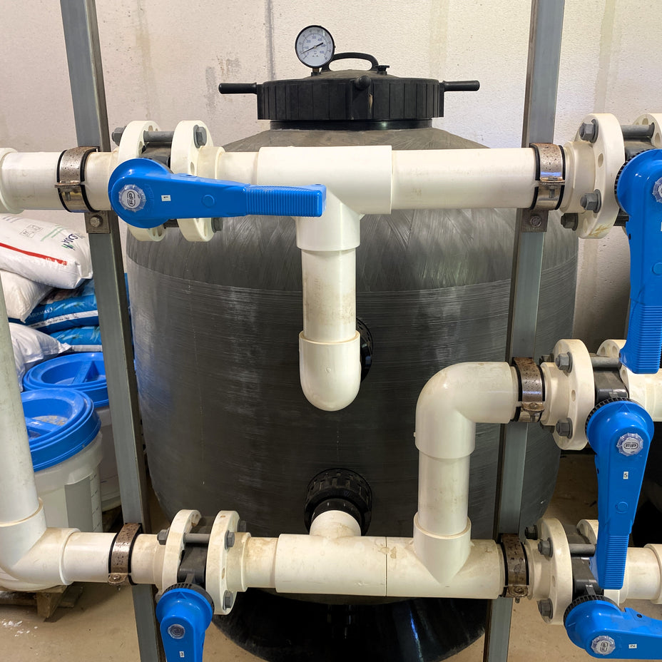 Filtration system with pipes and valves in a commercial pool plant room